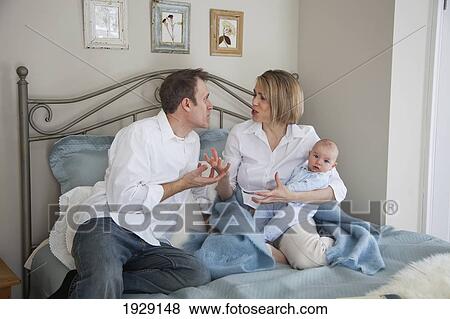 parents argue while holding a baby; jordan, ontario, canada View Large Photo Image Stock Photo - parents argue while holding a baby; jordan, ontario, canada. Fotosearch