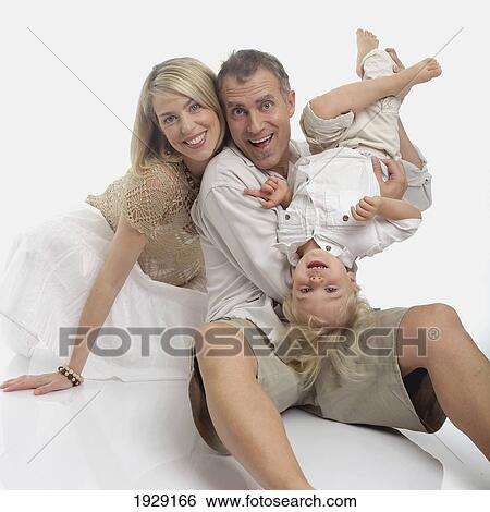 playful portrait of mother, father and toddler son View Large Photo Image Stock Photograph - playful portrait of mother, father and toddler son. Fotosearch