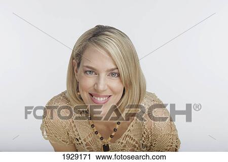 Stock Image - portrait of blonde woman against white background. Fotosearch