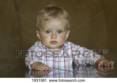 Stock Image - portrait of blue-eyed blonde male toddler. Fotosearch
