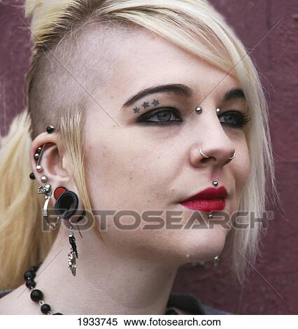 Stock Photography - portrait of girl with full face piercings; whitley bay, tyne and wear, england. Fotosearch