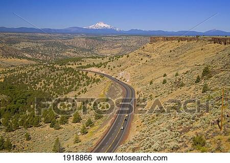 Stock Photograph - road with mount hood in the background; oregon, usa. Fotosearch