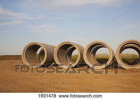 row of storm sewer pipes ready to install; st. albert, alberta, canada View Large Photo Image Stock Photo - row of storm sewer pipes ready to install; st. albert, alberta, canada. Fotosearch
