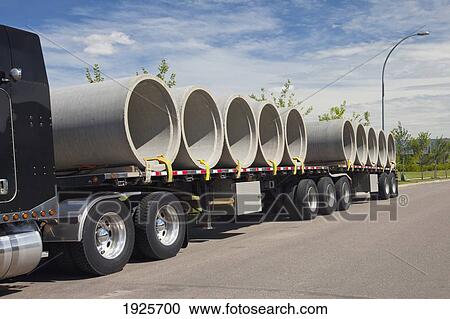 Stock Image - semi-trailer truck carrying sewer pipes; edmonton, alberta, canada. Fotosearch