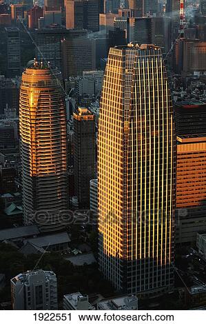 Stock Image - skyscrapers at sunset; tokyo, japan. Fotosearch