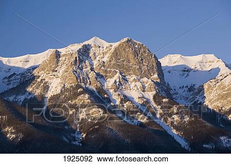 snow-capped mountain at sunrise; canmore, alberta, canada View Large Photo Image Stock Image - snow-capped mountain at sunrise; canmore, alberta, canada. Fotosearch