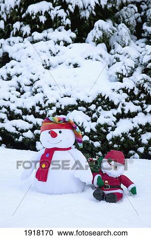 Stock Image - snowman with santa claus doll; whitburn, tyne and wear, england. Fotosearch