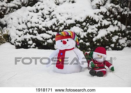 Stock Image - snowman with santa claus doll; whitburn, tyne and wear, england. Fotosearch