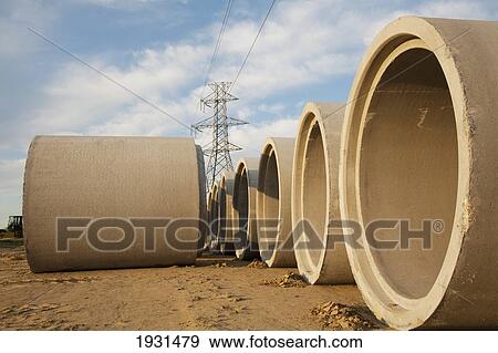 Stock Photo - storm sewer pipes ready to install; st. albert, alberta, canada. Fotosearch