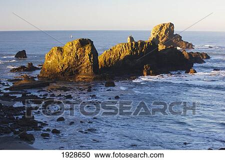 sun shining on the rocks at sunrise at ecola state park; oregon, united states of america View Large Photo Image Stock Image - sun shining on the rocks at sunrise at ecola state park; oregon, united states of america. Fotosearch