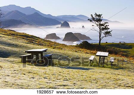 Stock Photo - sunrise and morning fog add beauty to cannon beach and haystack rock from ecola state park; oregon, united states of america. Fotosearch