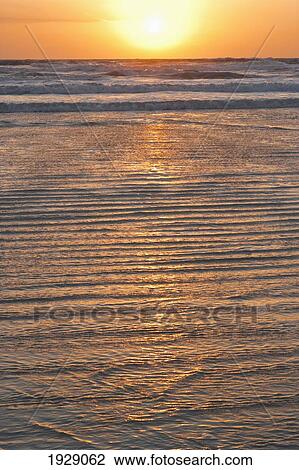 sunrise over breaking waves with water rippling over shore; florida, united states of america View Large Photo Image Stock Image - sunrise over breaking waves with water rippling over shore; florida, united states of america. Fotosearch