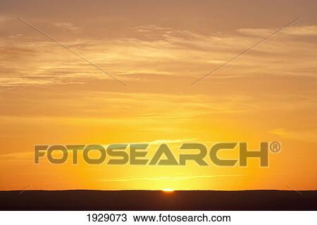 Stock Image - sunrise over the level horizon; florida, united states of america. Fotosearch