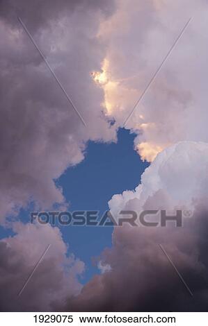 Stock Photography - sunset light within storm clouds; new mexico, usa. Fotosearch