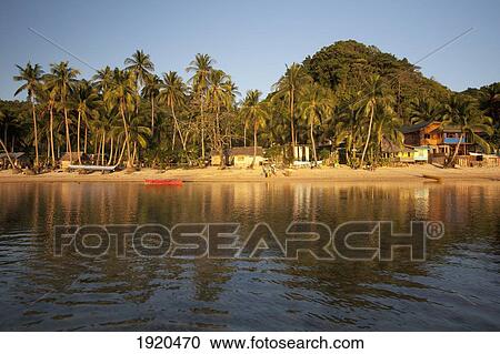Stock Image - the tropical village of corong corong near el nido at sunset; corong corong, bacuit archipelago, palawan, philippines. Fotosearch