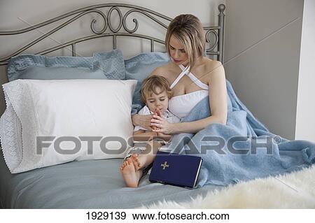 toddler and mother in bed praying together; jordan, ontario, canada View Large Photo Image Stock Photo - toddler and mother in bed praying together; jordan, ontario, canada. Fotosearch
