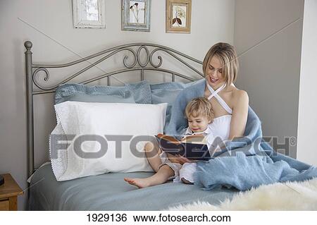 toddler and mother in bed reading; jordan, ontario, canada View Large Photo Image Stock Photograph - toddler and mother in bed reading; jordan, ontario, canada. Fotosearch