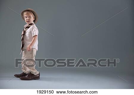 Stock Image - toddler with big shoes and a hat; jordan, ontario, canada. Fotosearch