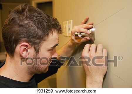 tradesman installing towel bar on wall View Large Photo Image Stock Photo - tradesman installing towel bar on wall. Fotosearch
