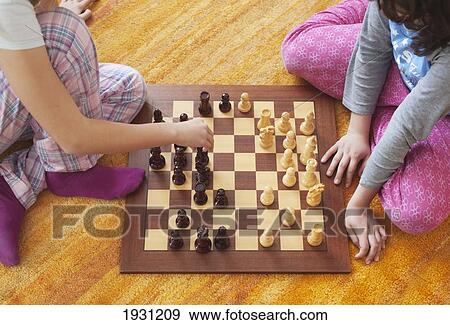 Stock Photo - two girls playing chess; tarifa, cadiz, andalusia, spain. Fotosearch