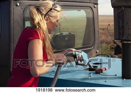 woman gassing up farm machinery; three hills, alberta, canada View Large Photo Image Stock Photo - woman gassing up farm machinery; three hills, alberta, canada. Fotosearch