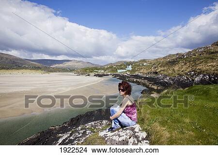 woman relaxing at beach; derrynane beach, county kerry, ireland View Large Photo Image Picture - woman relaxing at beach; derrynane beach, county kerry, ireland. Fotosearch