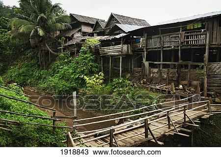 Stock Image - wooden pedestrian bridge across river; huay pu keng, thailand. Fotosearch