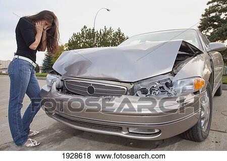 young woman with vehicle that has been in a collision; edmonton, alberta, canada View Large Photo Image Stock Photo - young woman with vehicle that has been in a collision; edmonton, alberta, canada. Fotosearch