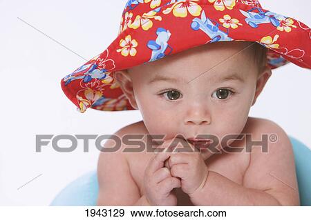 A Baby Boy Wearing A Hawaiian Hat; Troutdale Oregon United States Of America View Large Photo Image Stock Photo - A Baby Boy Wearing A Hawaiian Hat; Troutdale Oregon United States Of America. Fotosearch