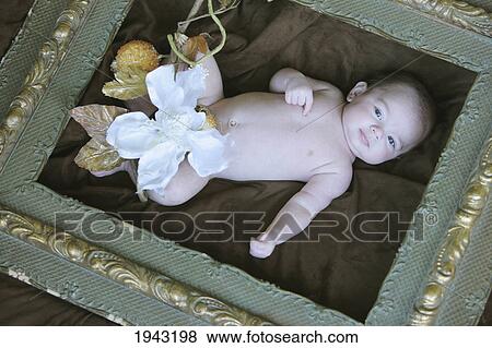 Stock Photo - A Baby Laying Inside A Picture Frame; Troutdale Oregon United States Of America. Fotosearch