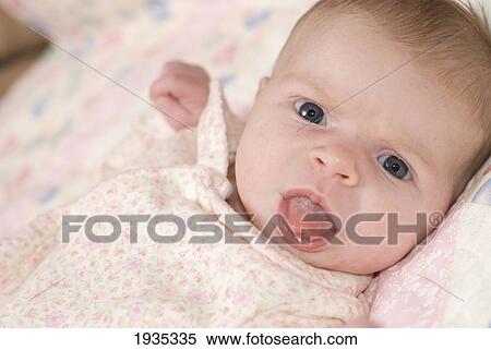 Stock Photography - A Baby Sticking Out Her Tongue; Alberta, Canada. Fotosearch