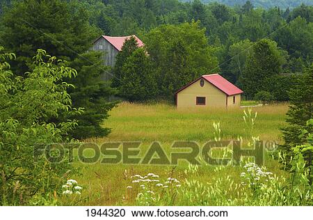 Stock Image - a barn and shed in a country meadow; fulford quebec canada. Fotosearch