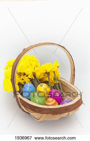 A Basket Of Yellow Flowers And Plastic Easter Eggs; Northumberland England View Large Photo Image Stock Photo - A Basket Of Yellow Flowers And Plastic Easter Eggs; Northumberland England. Fotosearch