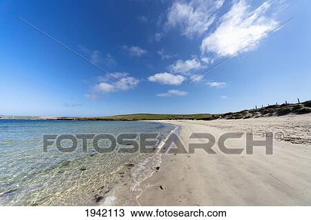 Stock Image - A Beach Along The Coast; Shetland Scotland. Fotosearch