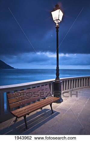 A Bench And Light Post Along The Railing On The Coast; Camogli Liguria Italy View Large Photo Image Stock Image - A Bench And Light Post Along The Railing On The Coast; Camogli Liguria Italy. Fotosearch
