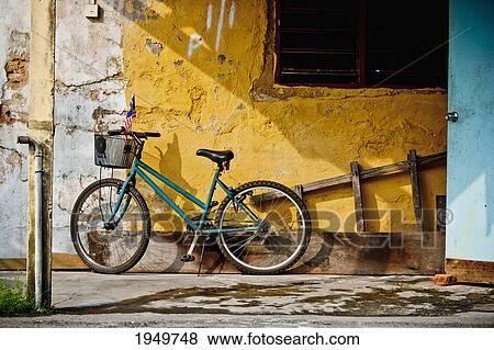 a bicycle parked against a wall; melaka malaysia View Large Photo Image Stock Photo - a bicycle parked against a wall; melaka malaysia. Fotosearch