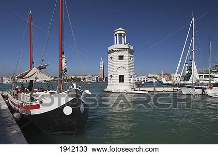 Stock Image - A Boat In The Water At San Giorgio Maggiore; Venice Italy. Fotosearch