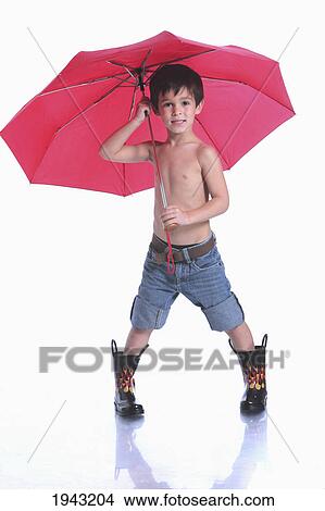 Picture - A Boy Wearing Rubber Boots And Holding A Red Umbrella; Troutdale Oregon United States Of America. Fotosearch