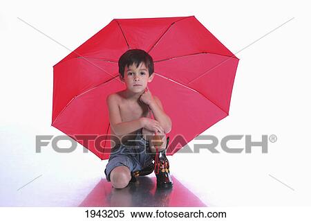 A Boy Wearing Rubber Boots And Holding A Red Umbrella; Troutdale Oregon United States Of America View Large Photo Image Stock Photography - A Boy Wearing Rubber Boots And Holding A Red Umbrella; Troutdale Oregon United States Of America. Fotosearch