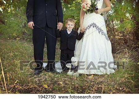 A Bride And Groom Holding A Young Boy's Hand; Edmonton Alberta Canada View Large Photo Image Stock Image - A Bride And Groom Holding A Young Boy's Hand; Edmonton Alberta Canada. Fotosearch