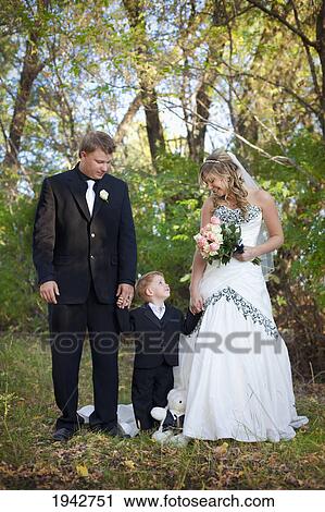 A Bride And Groom Holding A Young Boy's Hand; Edmonton Alberta Canada View Large Photo Image Stock Image - A Bride And Groom Holding A Young Boy's Hand; Edmonton Alberta Canada. Fotosearch