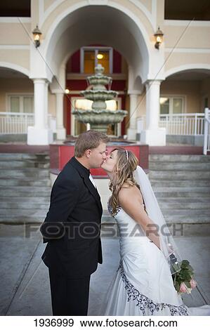 A Bride And Groom Kiss With A Water Fountain In The Background; Edmonton Alberta Canada View Large Photo Image Stock Photo - A Bride And Groom Kiss With A Water Fountain In The Background; Edmonton Alberta Canada. Fotosearch