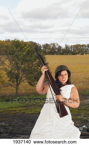 Stock Image - A Bride In Army Gear Ready For Combat; Pennock Minnesota United States Of America. Fotosearch