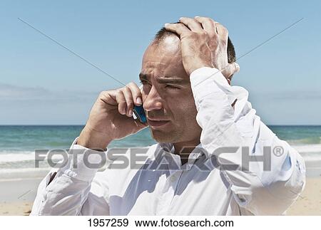 a businessman on the beach talking on his cell phone; tarifa cadiz andalusia spain View Large Photo Image Stock Photo - a businessman on the beach talking on his cell phone; tarifa cadiz andalusia spain. Fotosearch