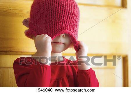 a child pulling a hat over her eyes; spruce grove alberta canada View Large Photo Image Stock Image - a child pulling a hat over her eyes; spruce grove alberta canada. Fotosearch