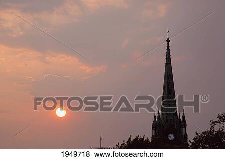 Stock Photo - a church steeple at sunset; trois rivieres quebec canada. Fotosearch