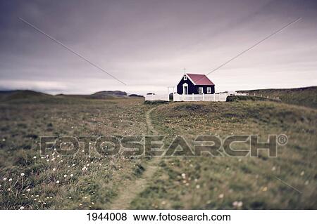 Stock Photo - A Church Surrounded By A White Picket Fence In The Wide Open Space; Papey Island Iceland. Fotosearch