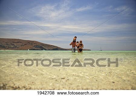 A Family Walks In The Ocean Water At Los Islotes National Marine Park Espiritu Santo Island; La Paz Baja California Mexico View Large Photo Image Stock Photo - A Family Walks In The Ocean Water At Los Islotes National Marine Park Espiritu Santo Island; La Paz Baja California Mexico. Fotosearch