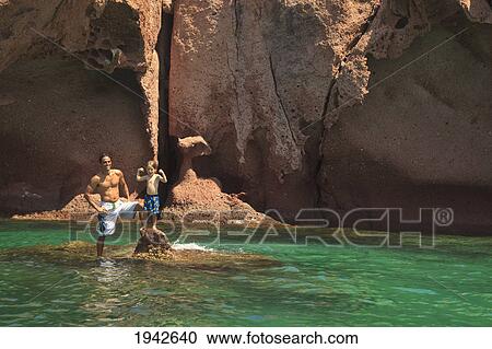 Stock Image - A Father And Son In The Water At Los Islotes National Marine Park Espiritu Santos Island; La Paz Baja California Mexico. Fotosearch