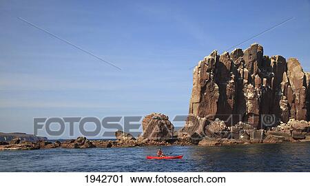 Stock Image - A Father And Son Paddle In A Red Boat At Los Islotes National Marine Park Espiritu Santo Island; La Paz Baja California Mexico. Fotosearch
